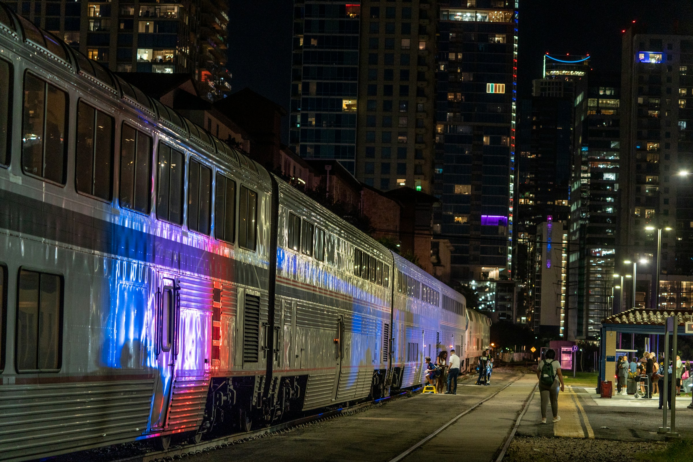 Passenger train at a city station at night